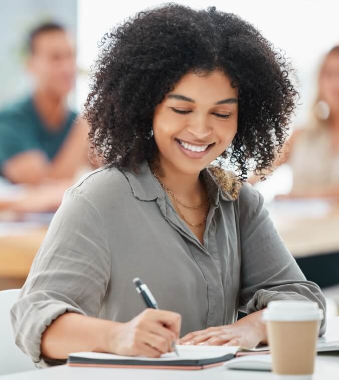 Young women writing down information while smiling